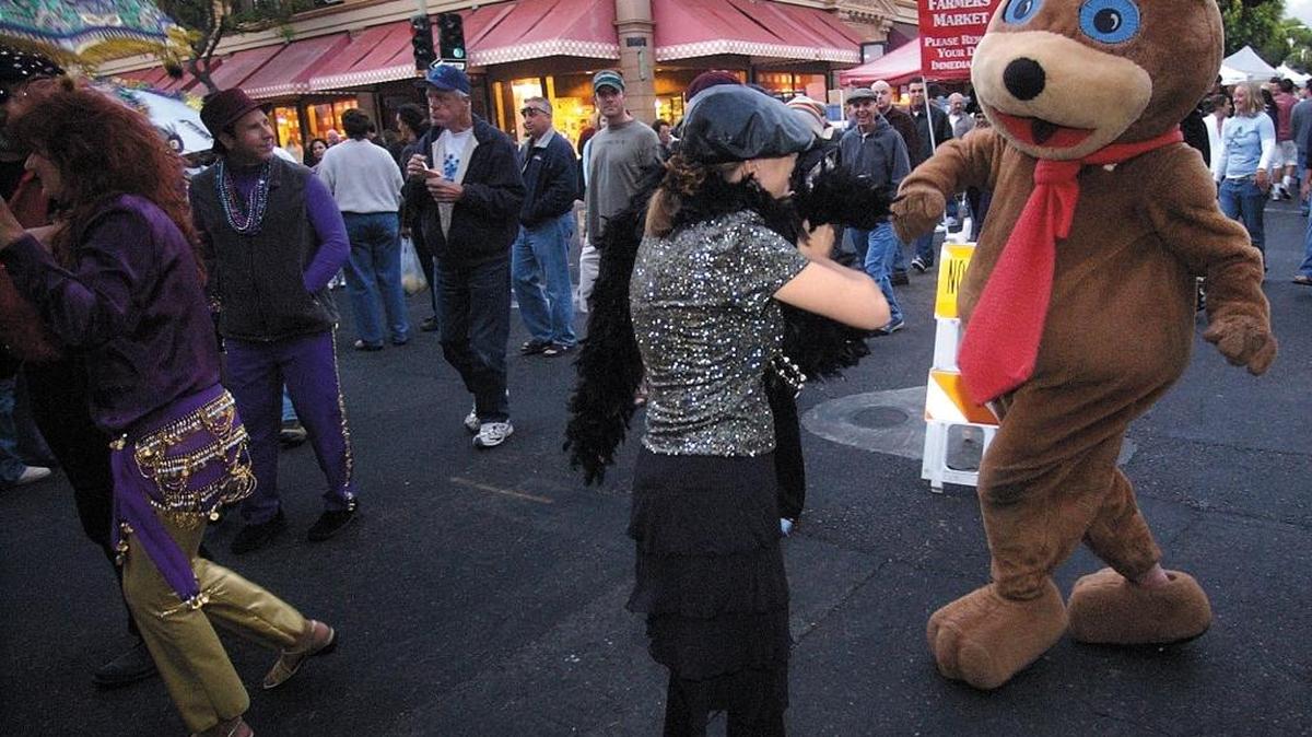 Downtown Brown, the mascot of the Downtown SLO Farmers Market, dances during a Mardi Gras celebration in 2004.