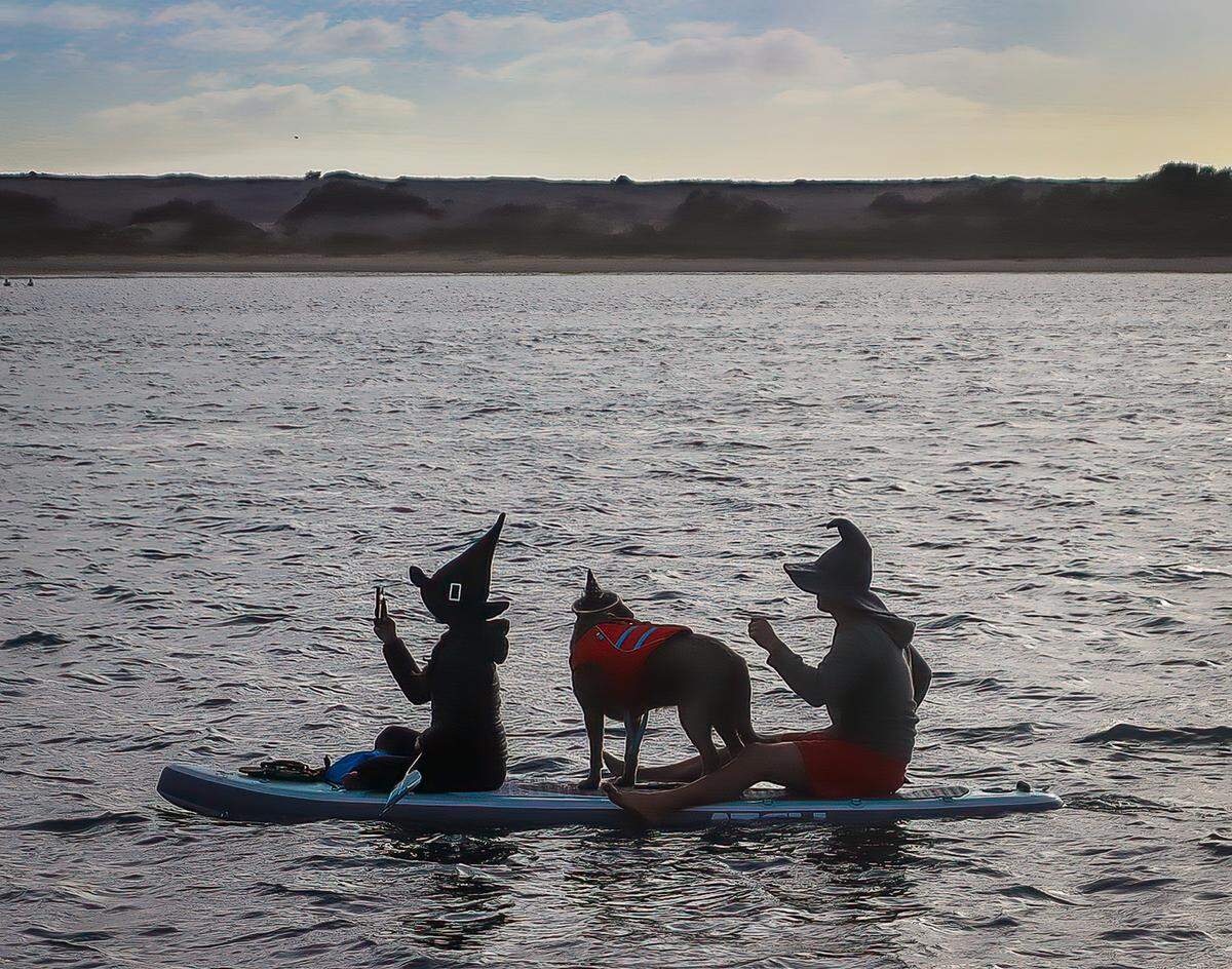 People dressed as witches and warlocks participate in the ninth annual Morro Bay Witches Paddle on Saturday, Oct. 22, 2022.