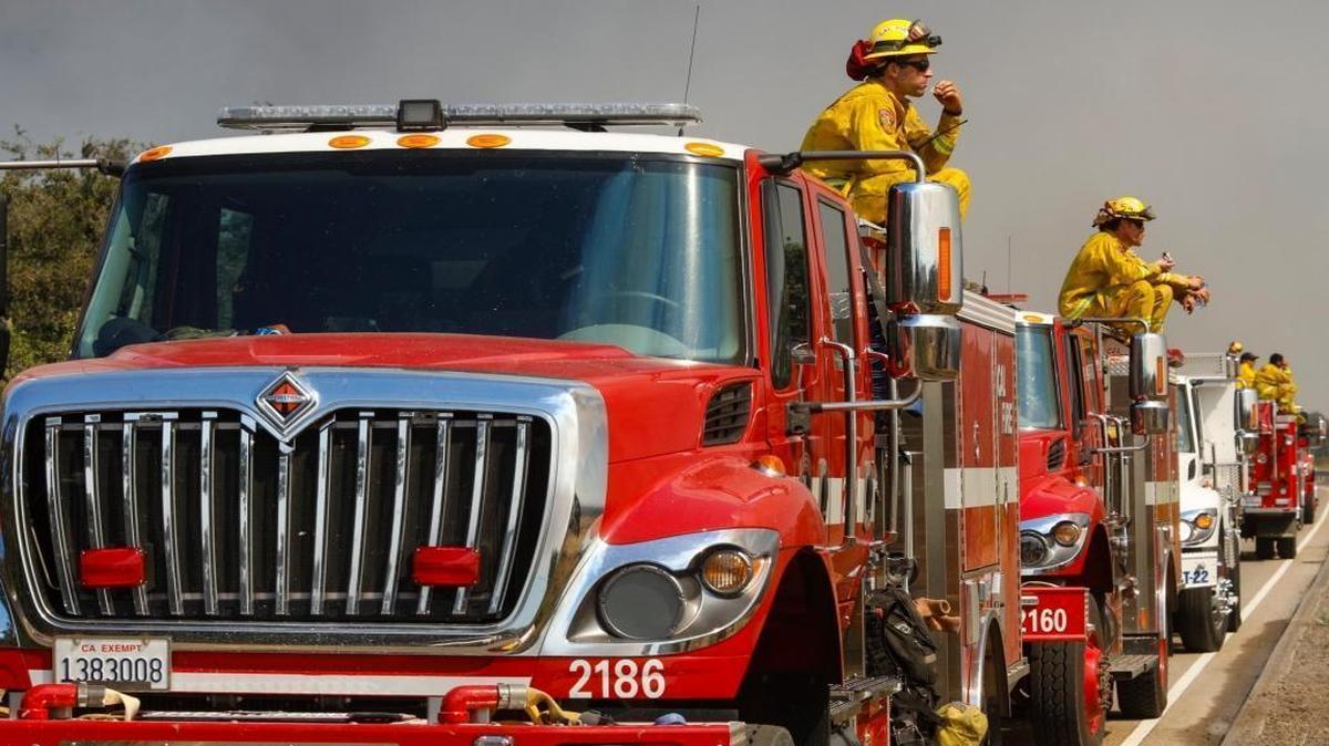 Firefighters take a meal break along Highway 166 as they monitor the Alamo Fire line. David Middlecamp 7-7-2017