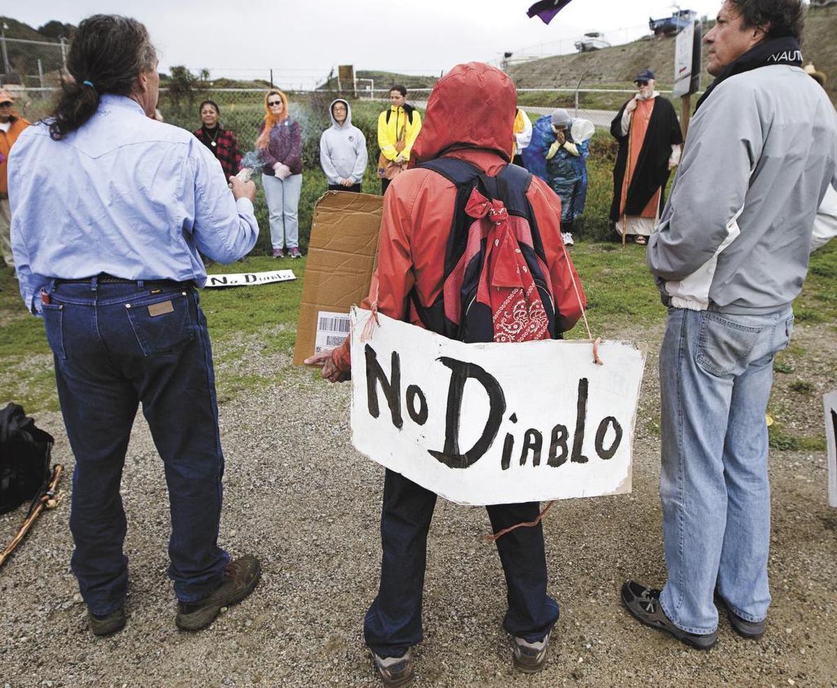 Bill Denneen of Nipomo, center, with his “No Diablo” sign during the Chumash blessing before the start of the December 2012 Walk for a Nuclear Free Future, a 12 mile walk for peace from the gates of Diablo Canyon Nuclear Power Plant to the courthouse in San Luis Obispo.