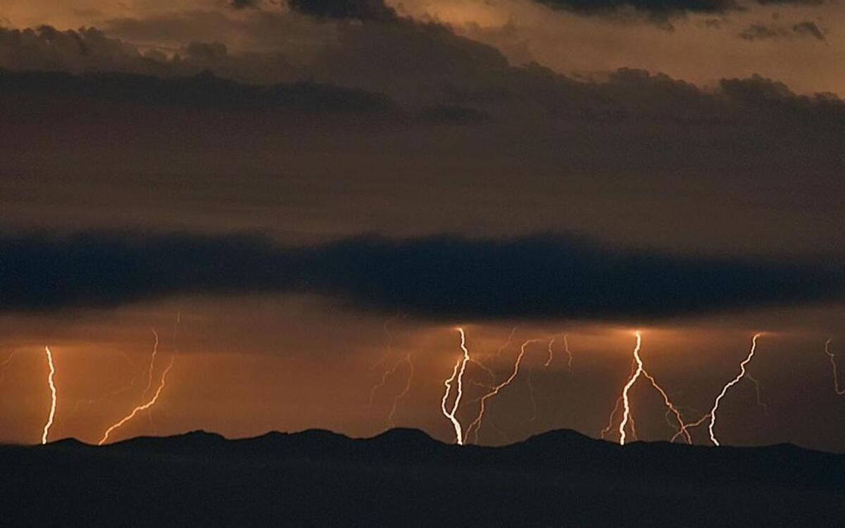 Lightning bolts are visible in the Santa Barbara Channel over Santa Cruz Island in this 30-second time exposure taken during Sunday night’s thunderstorms.