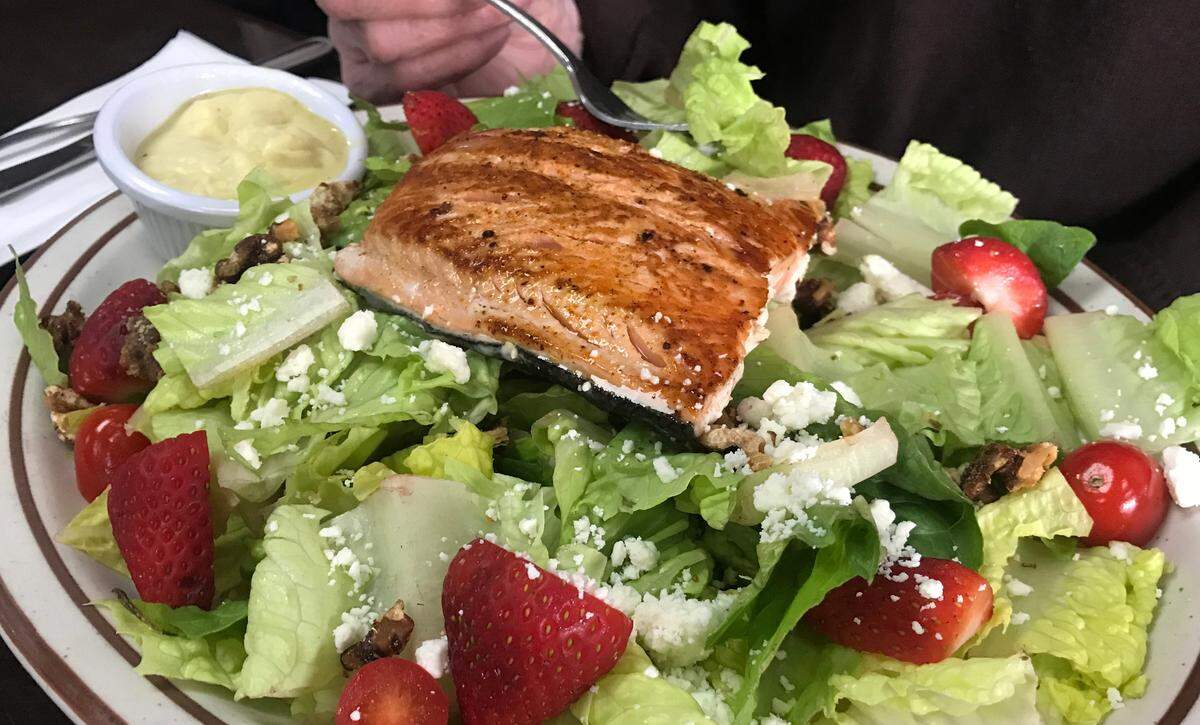 Cambria Cafe’s grilled salmon salad is embellished with strawberries, cherry tomatoes, candied walnuts and feta cheese, accented by a lemon vinaigrette.