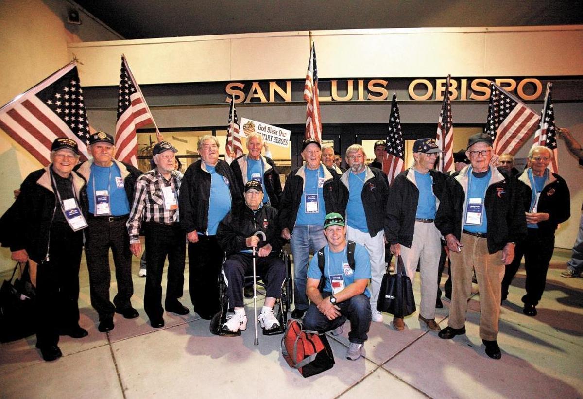 Thirteen World War II veterans gather outside the San Luis Obispo County Regional Airport terminal in April 2013 after returning from their Honor Flight trip to Washington, D.C.