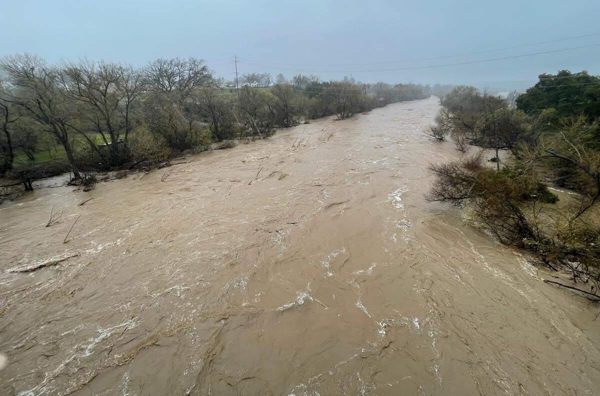 Flood debris and runoff rush down the Salinas River near downtown Templeton on Friday morning, March 10, 2023.