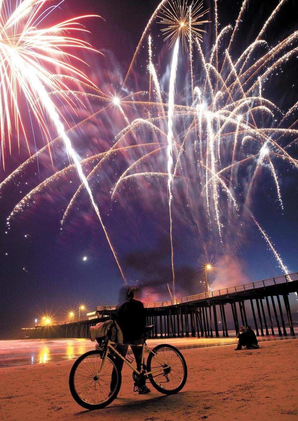 Danita Ross of Grover Beach watches the fireworks at the Pismo Beach Pier in 2017.