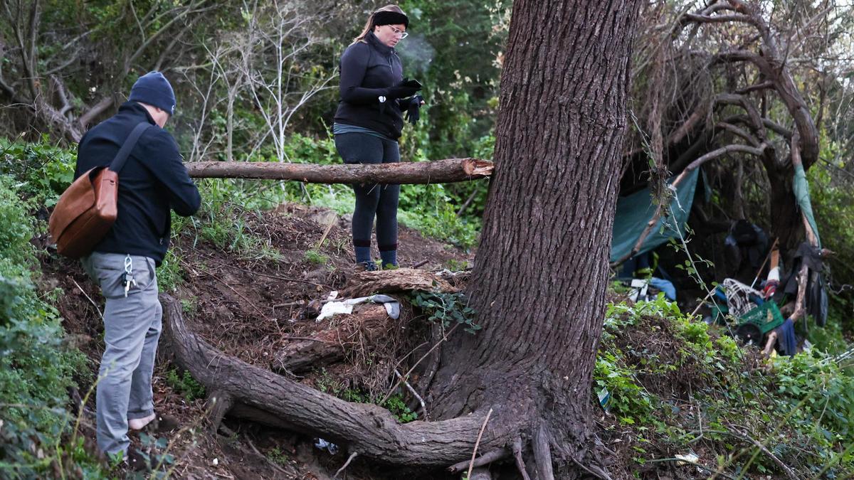 Jack Lahey and Kelsey Nocket document an active campsite in San Luis Creek near the Bob Jones Trail. Volunteers and staff were out before dawn to count the unhoused in the county on Feb. 23.
