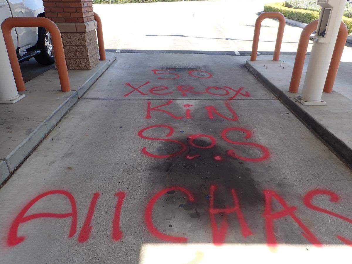 A bank drive-through and several other locations around Paso Robles were vandalized with bizarre messages spelled out in red spray paint. Police have arrested two suspects they believe are responsible for the graffiti.