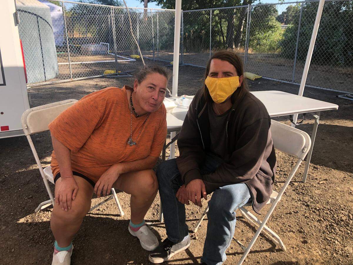 Sharon Schultz and her son, Joshua, came to get dinner at Paso Robles’ Borkey Flats homeless camp but were hesitant to stay there overnight. The pair have lived in Schultz’s car since they lost their housing four years ago.