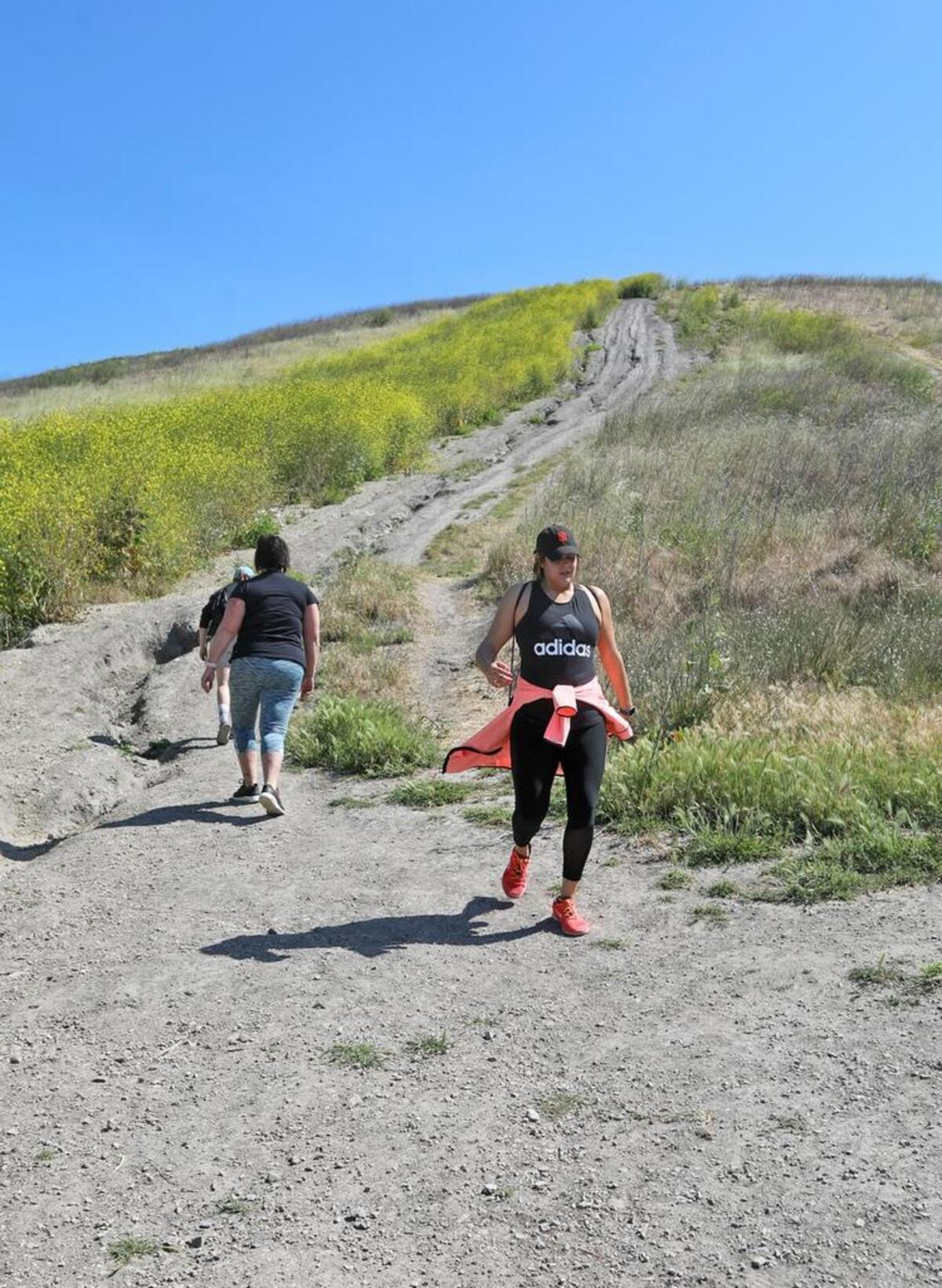 Hikers enjoy the Ontario Ridge Trail on a warm Sunday afternoon, April 23, 2017. Claire Vasquez, front, of Santa Maria comes down from the steep part of the trail.