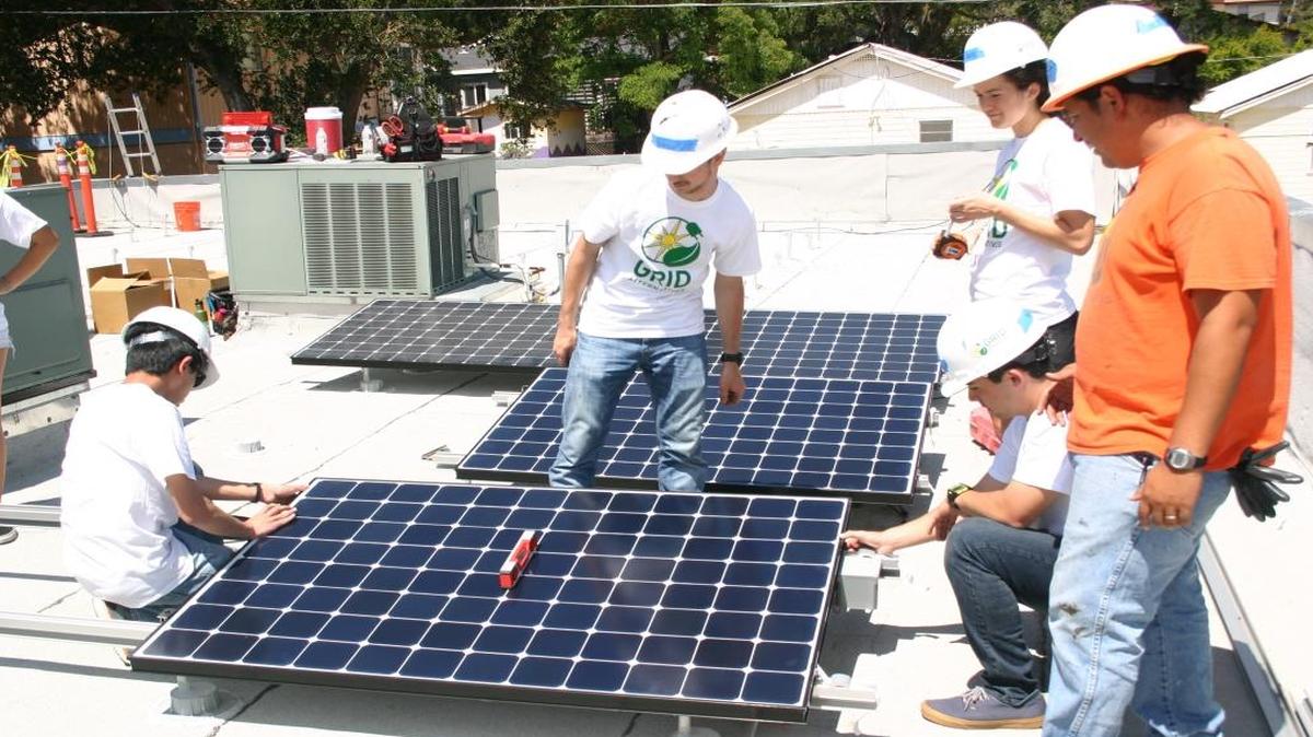 GRID Alternatives workers, along with Cal Poly students in the Project Solar program, install solar panels for Atascadero Loaves and Fishes.