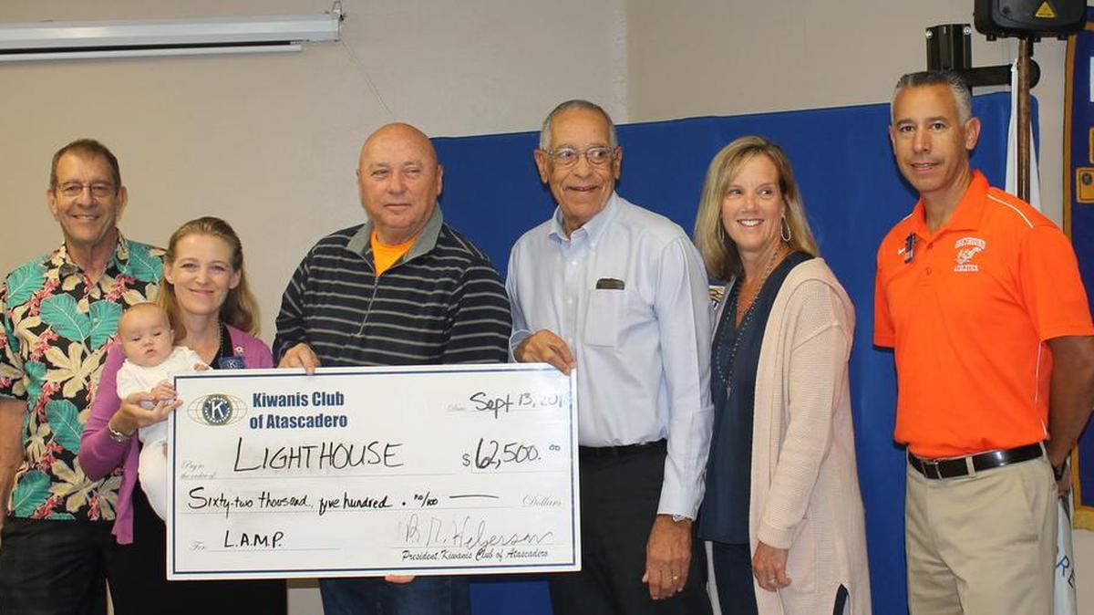 Holding the Atascadero Kiwanis Club $62,500 donation to the Atascadero Lighthouse program are, from left, Ron Helgerson, Kiwanis president; Heather Newsom (holding daughter Abigail), foundation treasurer; Jim Stecher, foundation president; Donn Clickard, foundation CEO; Lori Bagby, chairwoman of the Lighthouse Program; and E.J. Rossi, chairman of Social Solutions Foundation.