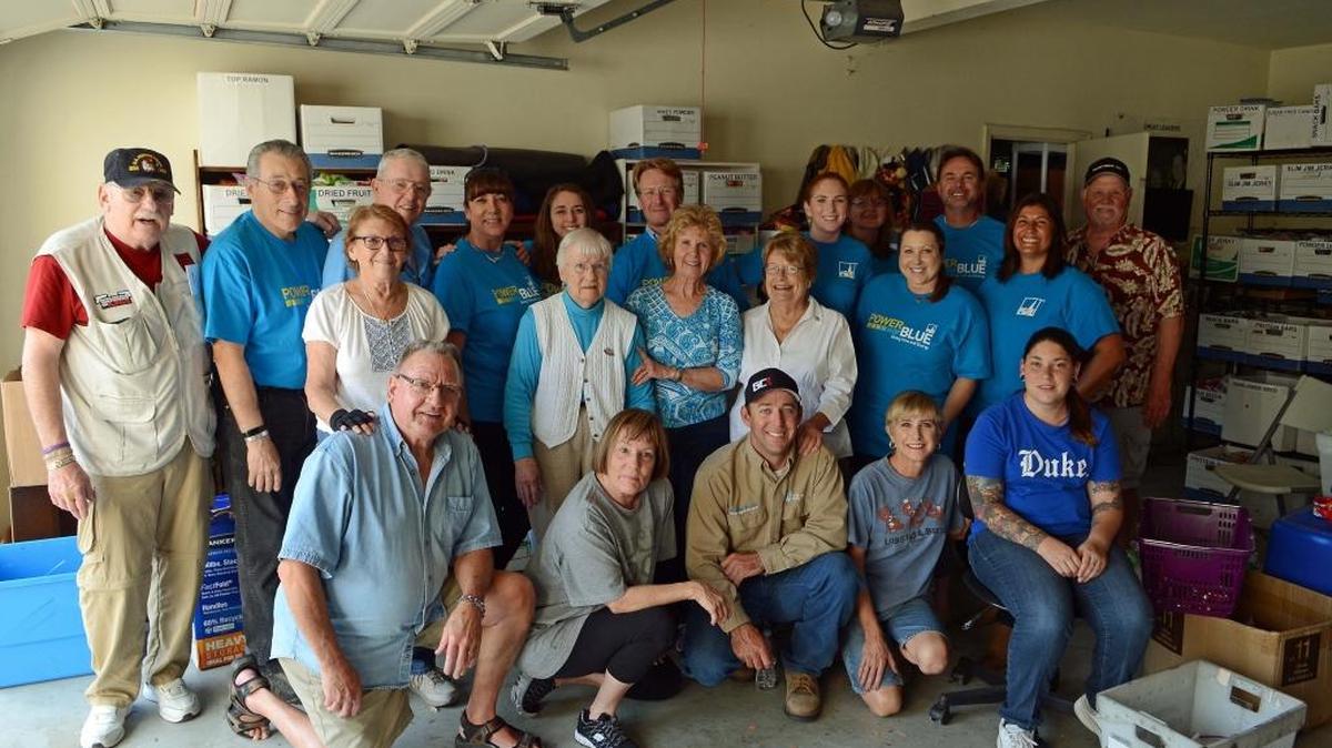 PG&E employees joined with other volunteers at Si Tenenberg’s home to assemble care packages for U.S. troops overseas.