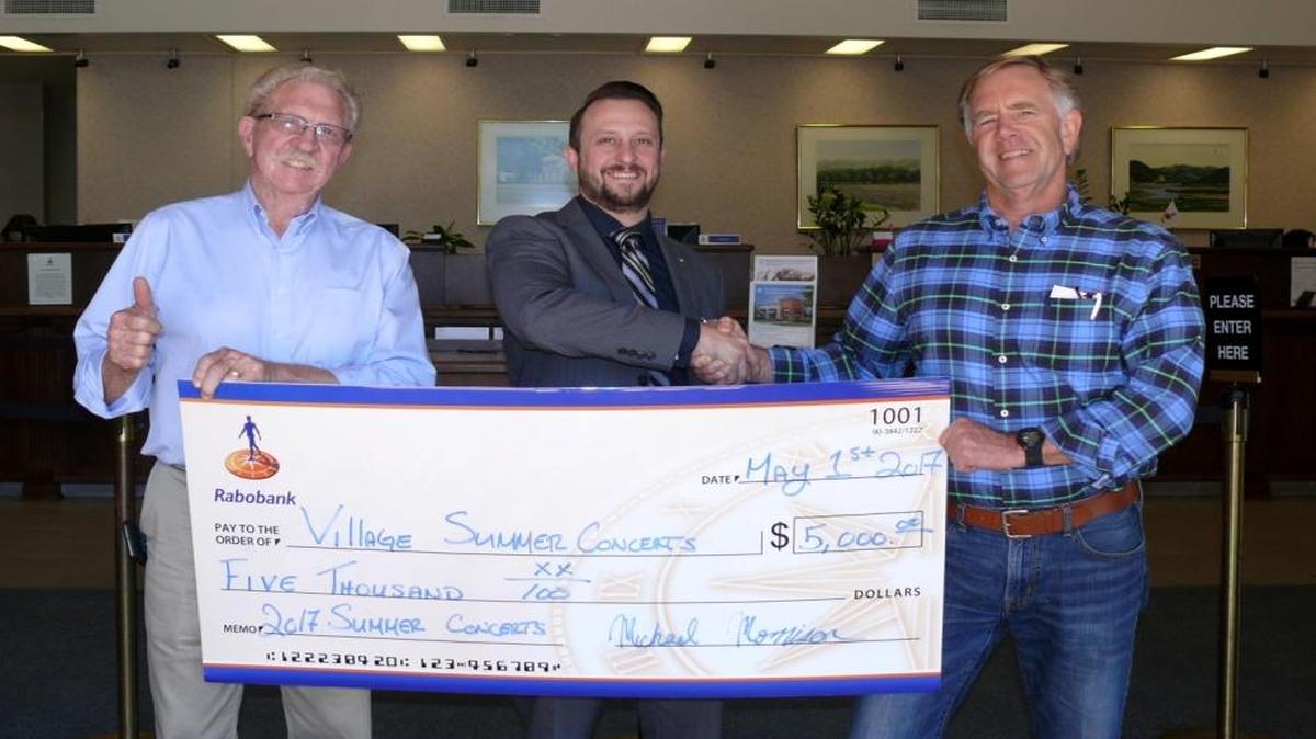 Bob Lund, president of the Arroyo Grande Village Improvement Association, left, and Curtis Reinhardt, Village Summer Concert Series manager, receive a donation from Michael Morrison, Rabobank branch manager/VP in Arroyo Grande. Rabobank is the overall sponsor of the Village Summer Concert Series.