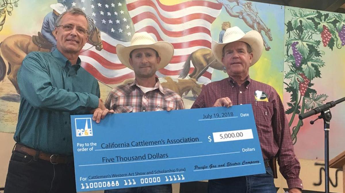 Accepting PG&E’s check in the amount of $5,000 for youth agriculture education were San Luis Obispo County Cattlemen’s Association Vice President Anthony Stornetta (center) and Cattlemen’s Association member/Cattlemen Day dinner emcee Pete Clarke.