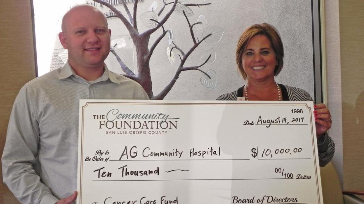 Len Smolburd, left, grants manager for The Community Foundation San Luis Obispo County, presents a check in the amount of $10,000 to Montisa Phelan Lopez, vice president of philanthropy of the Arroyo Grande Community Hospital Foundation.