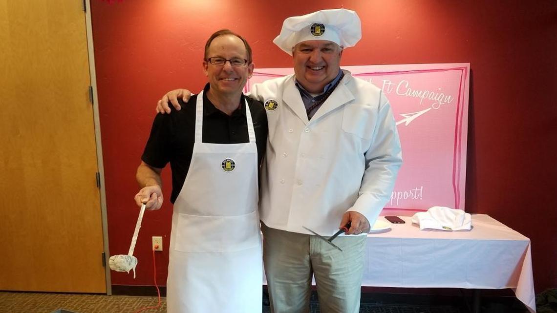 Mike Cannon, president and CEO of Cannon, left, flips pancakes with PG&E meteorologist John Lindsey at the Well Worth It pancake breakfast fundraiser.