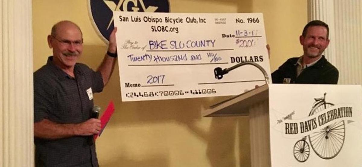 San Luis Obispo Bicycle Club President Dave Abrecht (left) presents a check for $20,000 to Bike SLO County Executive Director Mike Bennett.
