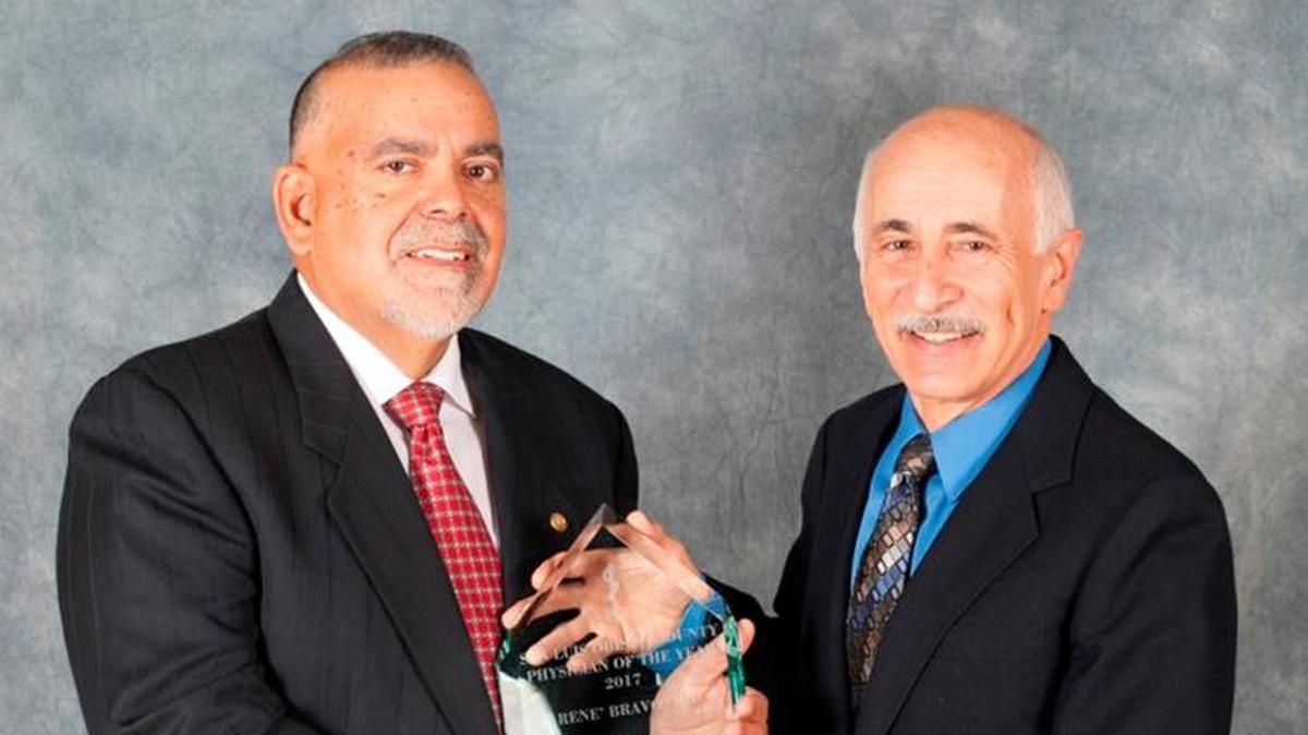 Dr. René Bravo, left, accepts his 2017 San Luis Obispo County Physician of the Year Award from Dr. Fred Vernacchia.
