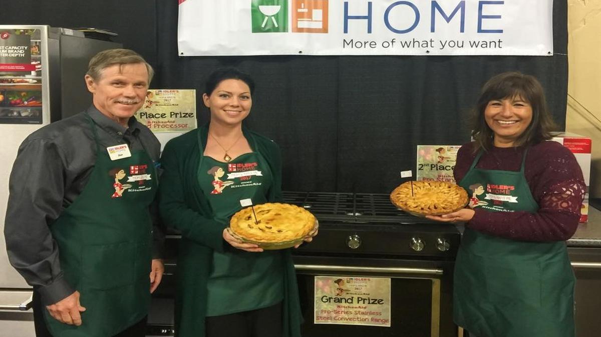 Don Idler, left, congratulates Delilah Curtis and Michelle Cole, third and first place winners, respectively, in Idler’s Home Mom and Apple Pie Contest. Not pictured is second place winner Cathy Vierra.