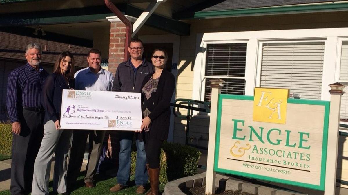 From left, Scott Engle, Jayne Engle-Allen and Travis Allen of Engle & Associates Insurance Brokers present a donation to Dave Axberg and Anna Boyd-Bucy of Big Brothers Big Sisters of SLO County.