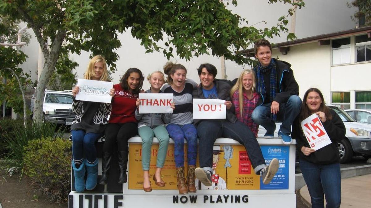Students of San Luis Obispo Little Theatre’s Academy of Creative Theatre hold up signs of thanks to The Community Foundation San Luis Obispo County for a grant to fund scholarships for students participating in ACT educational programs.