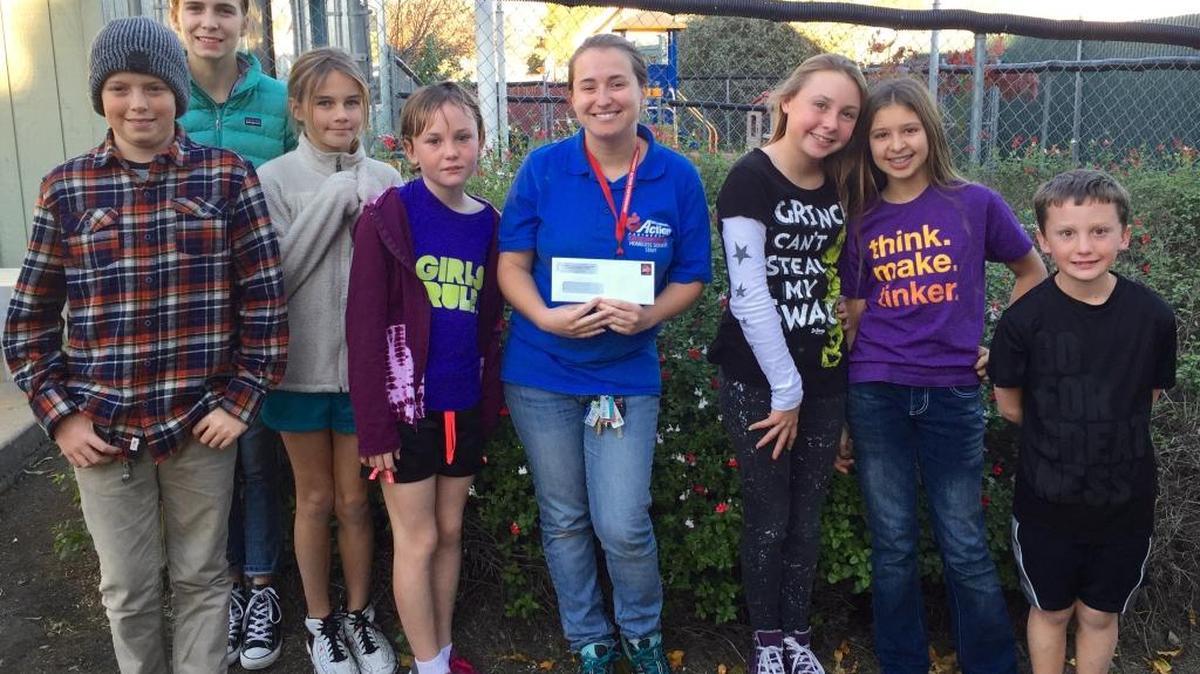 Children from the Unitarian Universalist Fellowship of San Luis Obispo recently held a bake sale earning $180, which they donated to the Prado Day Center. From left are Scott Murphy, Lexi Steinmaus, Tasha Steinmaus, Chelsea (Prado Day Center staff), Peyton Ernest, Paige Ernest, Tekuru Lofgren and Elliott Ernest.