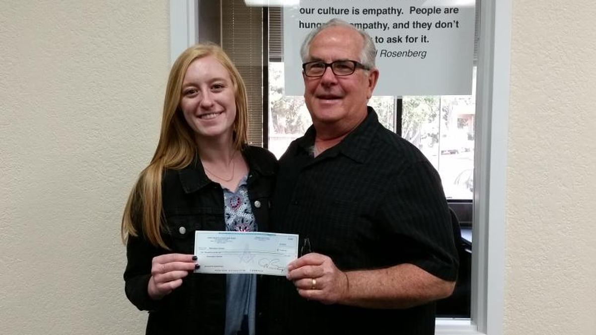 Robyn Morton, Restorative Partners assistant in-custody program director, receives a $2,000 donation from King David’s Masonic Lodge representative Ron Tilley.