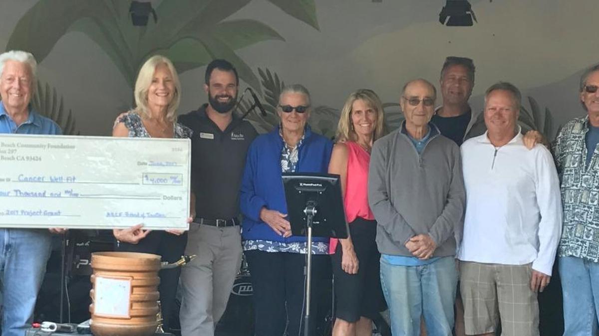 From left, Cancer Well-Fit participant Jim Long, Cancer Well-Fit Director Jan Secord, Avila Bay Club assistant manager Travis Hawley, Foundation trustees Lucinda Borchard, Cyndy Lakowske, Saul Goldberg, Mike Ginn and Gary Maier, and Avila Beach Community Foundation Executive Director Rick Cohen celebrate the presentation of a check for $4,000 to the Cancer Well-Fit Program.