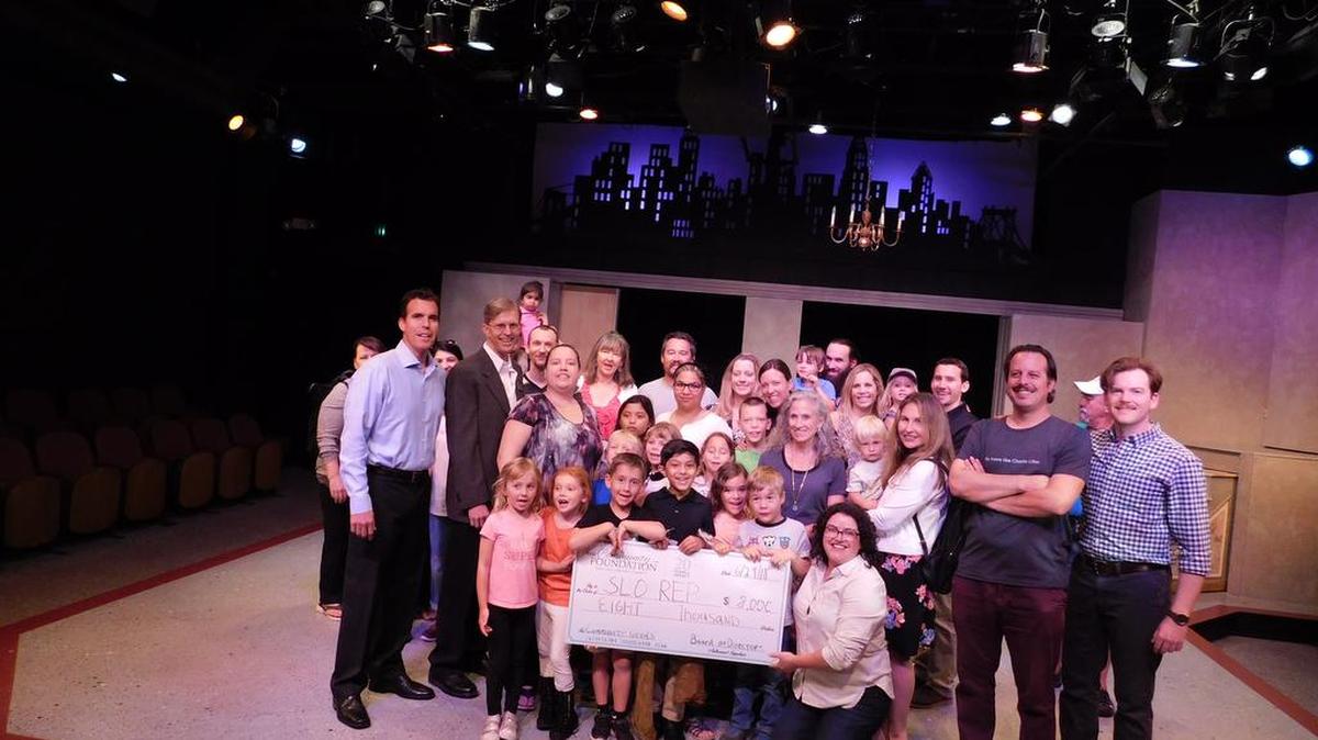Students and families from SLO REP’s ACT summer camp program celebrate the Community Foundation’s $8,000 grant with SLO REP board members Ken Craig and Jeff Olds, education director Kerry DiMaggio, ACT instructor Mike Fiore and managing artistic director Kevin Harris.