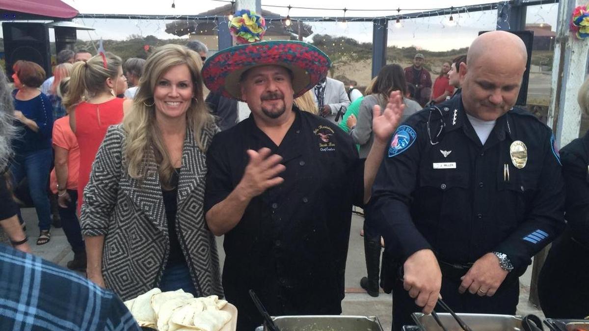 Volunteer servers county Supervisor Lynn Compton, left, and Pismo Beach Police Chief Jake Miller, right, help Fin’s chef Carlos del Rio, center, at the Fiesta at Fin’s fundraiser on Cinco de Mayo.