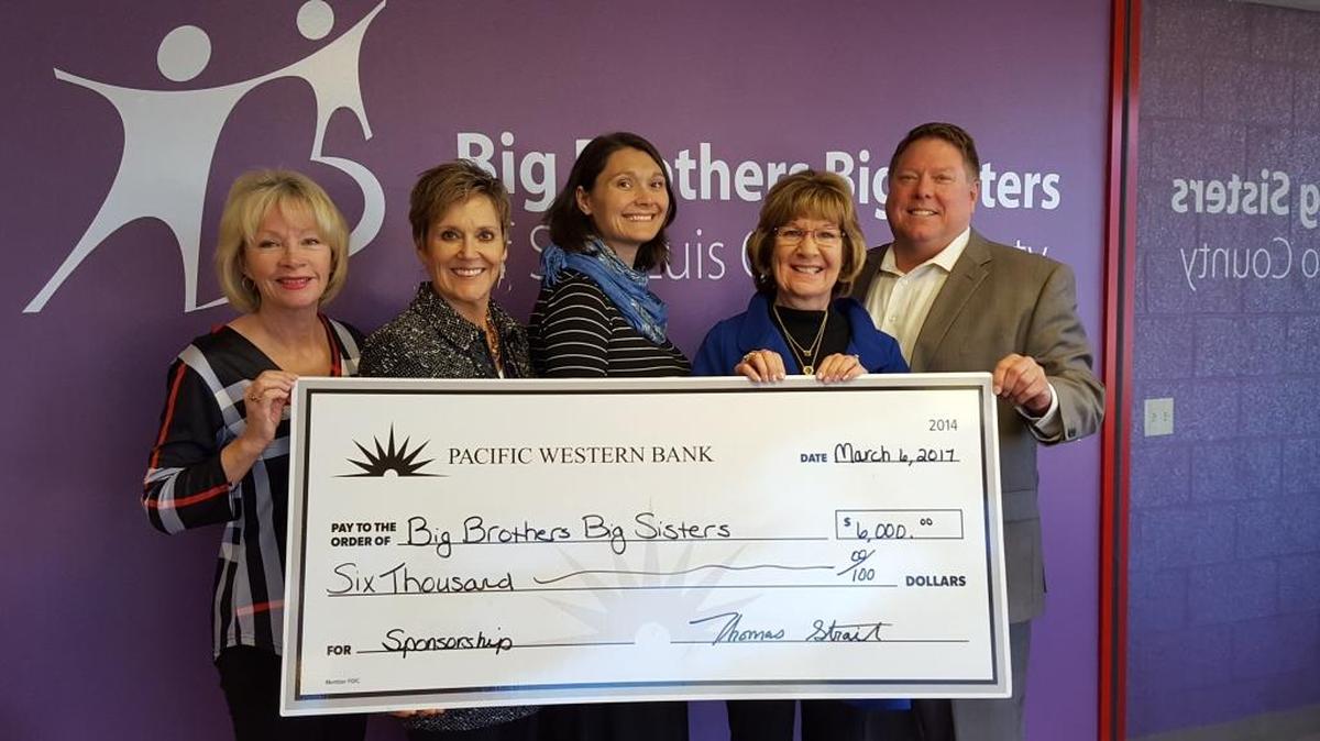 From left, Karen Colombo, Patty Carpenter and Anna Boyd-Bucy of Big Brothers Big Sisters receive a donation from Pacific Western Bank’s Lynda Nahra and Tom Strait.