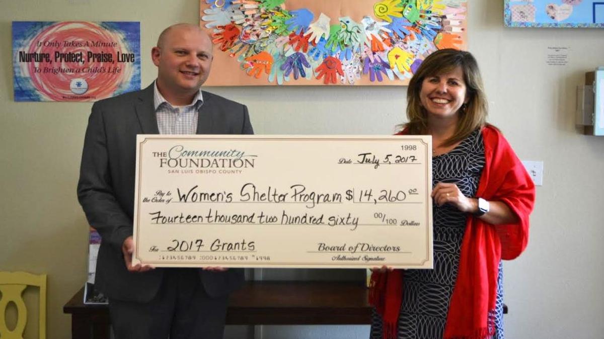 From left, Len Smolburd, grants manager for the Community Foundation San Luis Obispo County presents Kirsten Rambo, executive director of the Women’s Shelter Program of San Luis Obispo County, with a check for $14,260.
