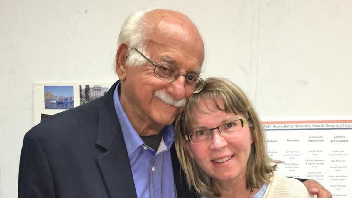 Paul Wolff presents Beverly Gingg a plaque commemorating her late husband, Bryan Gingg, a longtime supporter of Access for All.