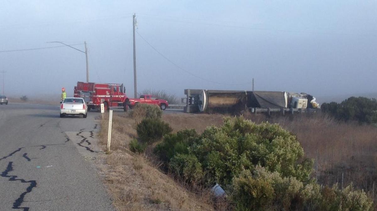 A tractor-trailer rig is seen resting on its side after a crash at Highway 1 and Highway 46 south of Cambria.