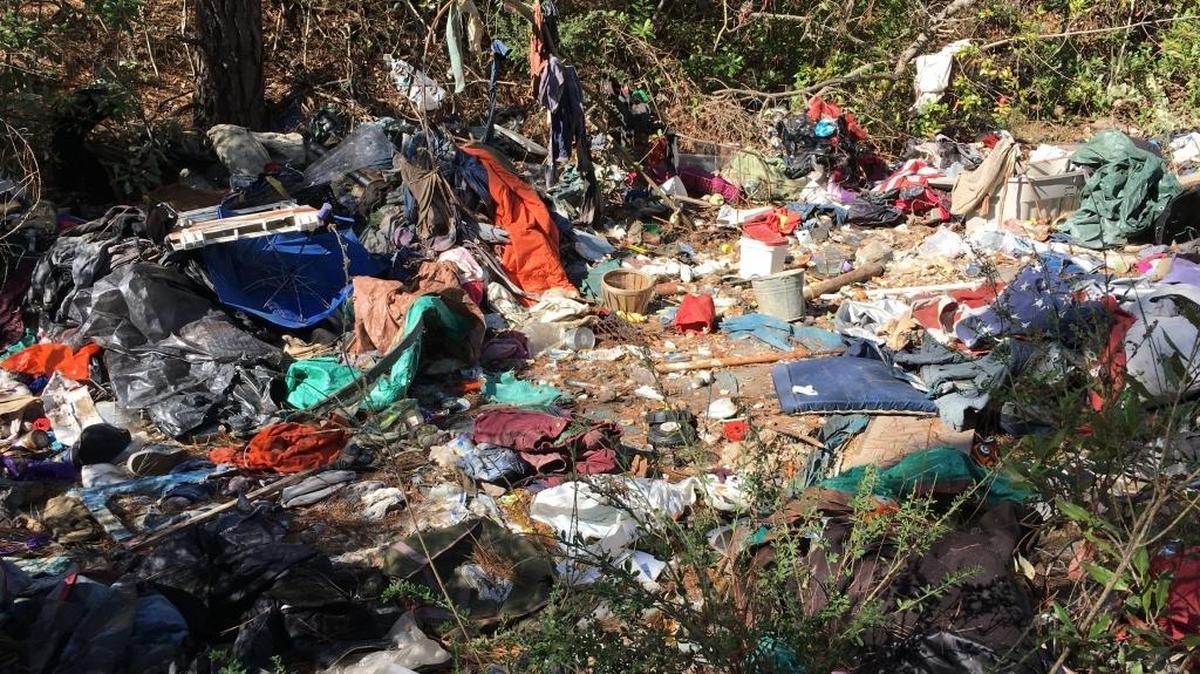 Trash is strewn across a recently uncovered Cambria-area homeless camp.