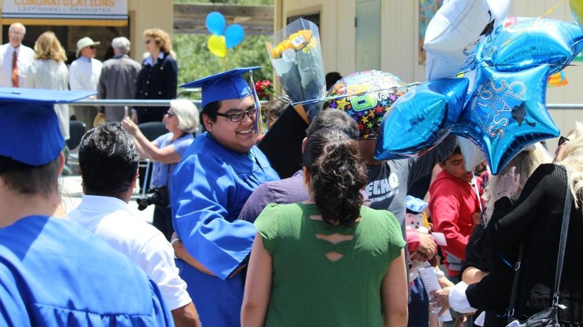 Brayan Pena, center, visits with members of the audience after Leffingwell Continuation High School’s 2017 graduation.