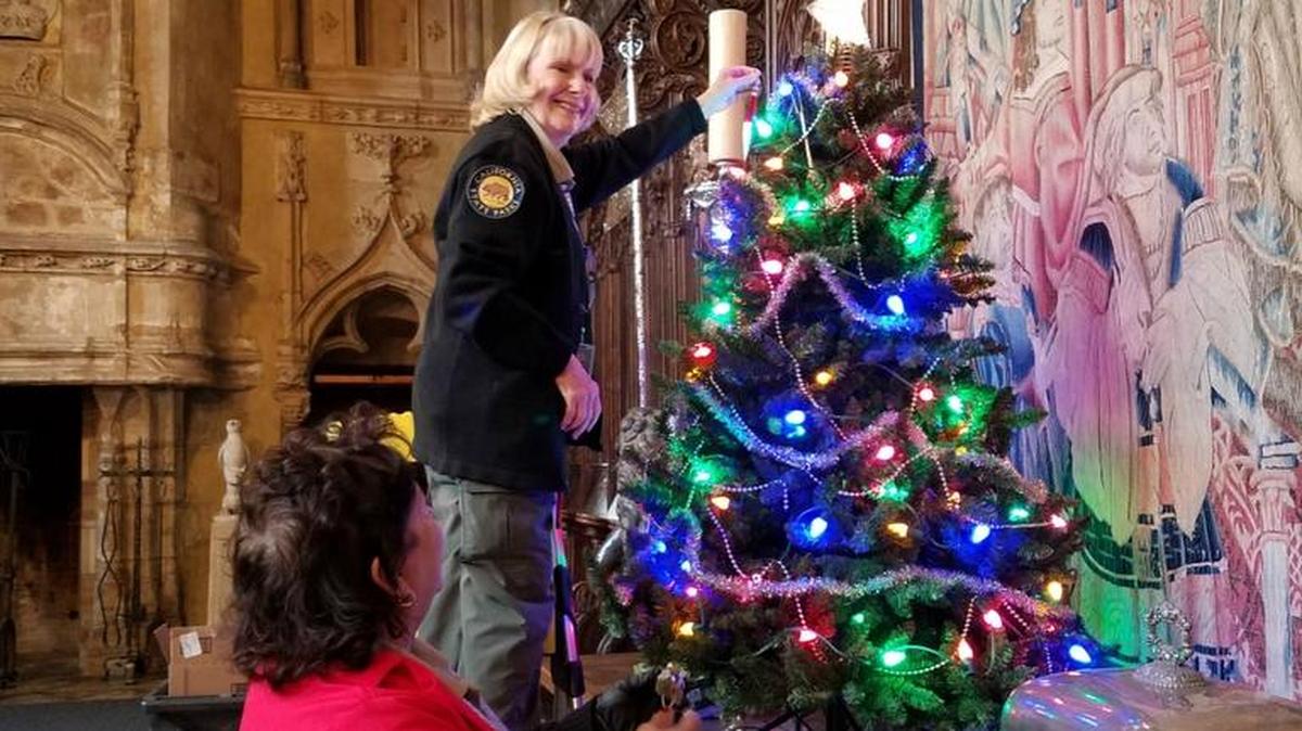 Nancy Requiro, on the ladder, and Lydia Salinas help decorate Hearst Castle for the holidays.