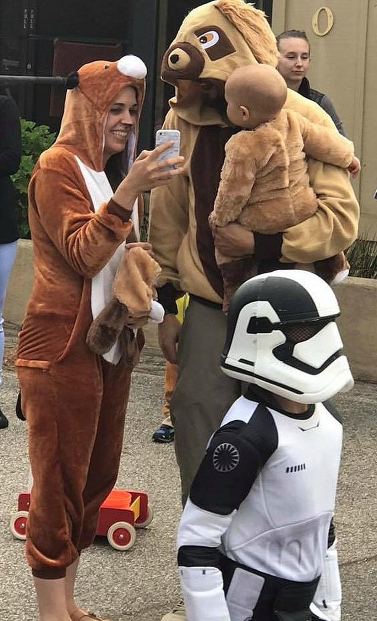 A canine family and a miniature stormtrooper prepare to set out in search of treats in Cambria’s West Village on Tuesday.