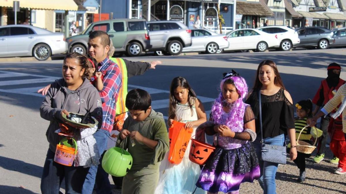 Young Cambria trick-or-treaters check their growing haul of candy during the Halloween parade through West Village on Oct. 31.