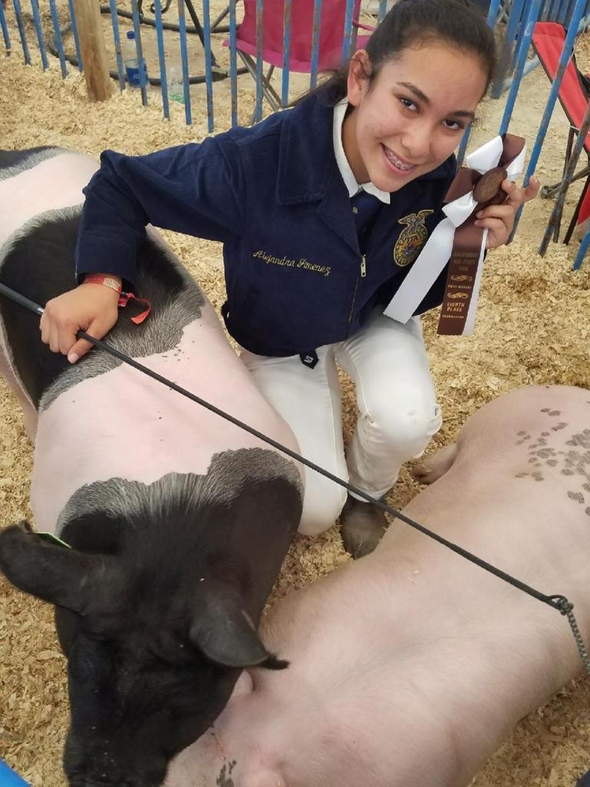 FFA member Emma Sison — her hand is on her pig, “Manteca” — placed eighth in the Championship Drive for Showmanship at the Californai Mid-State Fair on Saturday, July 29.
