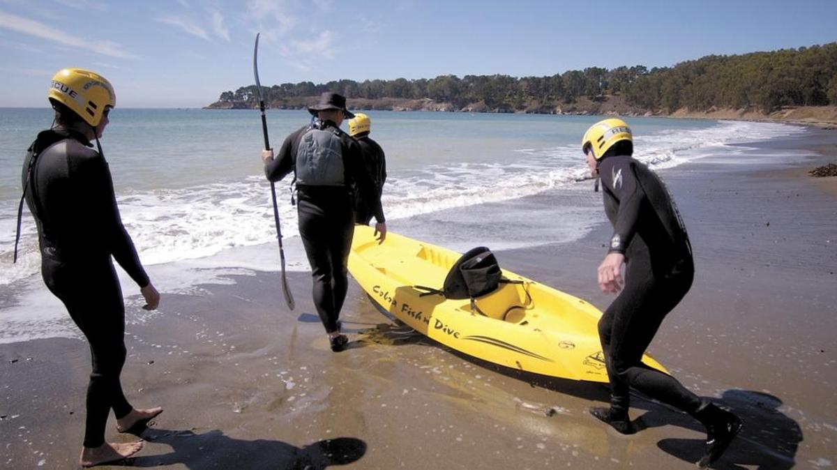 Kayaker Jim Masy, (in hat with paddle) gets assistance from the North Coast Ocean Rescue members in this photo from 2002. Participants in the Oct. 7 Pier-to-Point Fun Paddle can use any human-powered ocean craft, including kayaks, paddleboards, stand-up paddleboards and outrigger canoes.