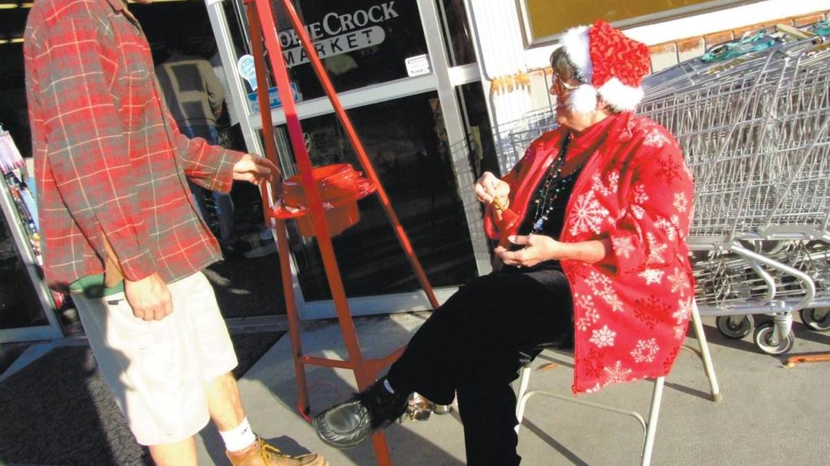 A Salvation Army kettle is tended by Cambrian reporter Kathe Tanner at the Cookie Crock supermarket in 2007. There are no Salvation Army bell-ringers in Cambria this year.