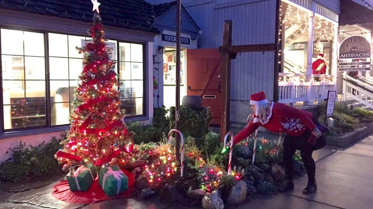 Cambria Visitor Center volunteer Lesley Hochshild checks the Visitor Center’s holiday display during Hospitality Night 2014.