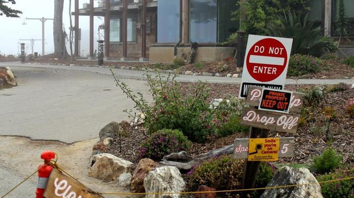 Signs outside the closed Centrally Grown complex tell visitors to “keep off” and that they are being monitored on camera.