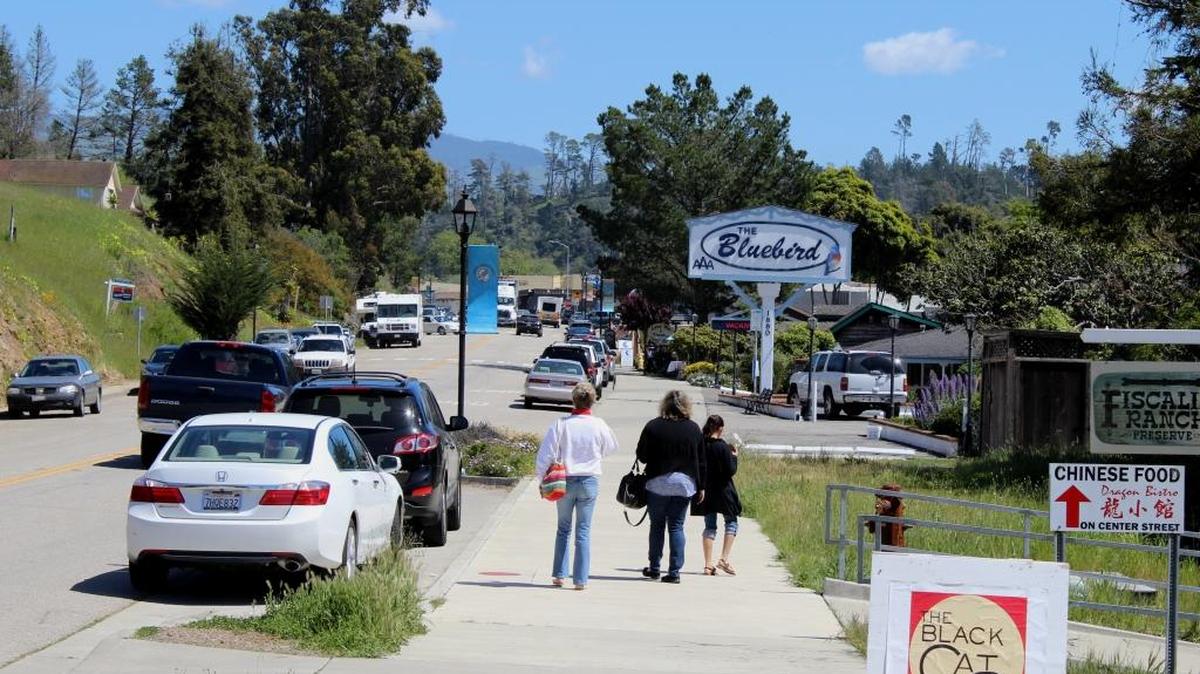 Pedestrians walk down Main Street in Cambria’s East Village.