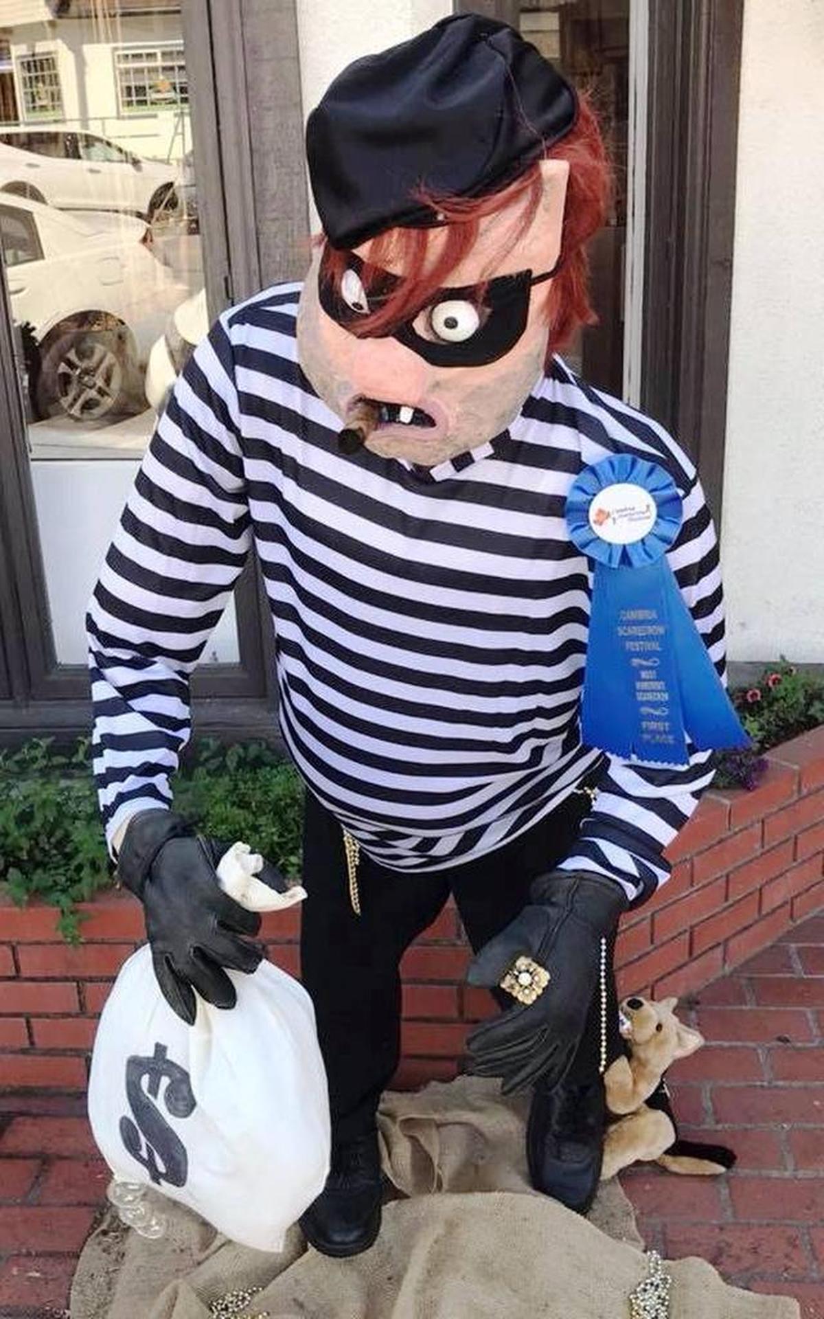 A little canine has this would-be robber by the heel in “Doggie Catcher” by Joanne and Ed Yenshaw, the Best Humorous Scarecrow at 786 Main St.