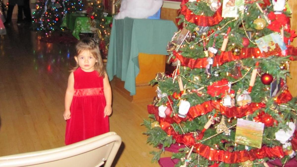 Viviana McLean-Ponce stands by a tree at the Cambria Christmas Tree Auction in 2015.