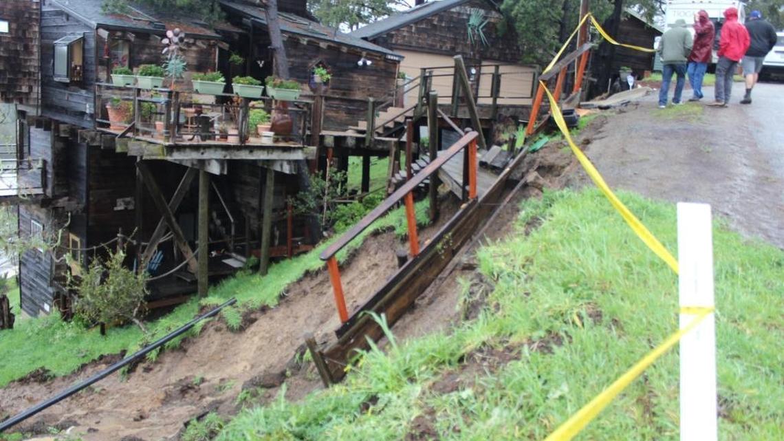 Part of a hillside along Pineknolls Drive in Cambria gave way around midday Friday, undercutting an exterior stairway and cutting off a sewer line. The residents were told to evacuate.