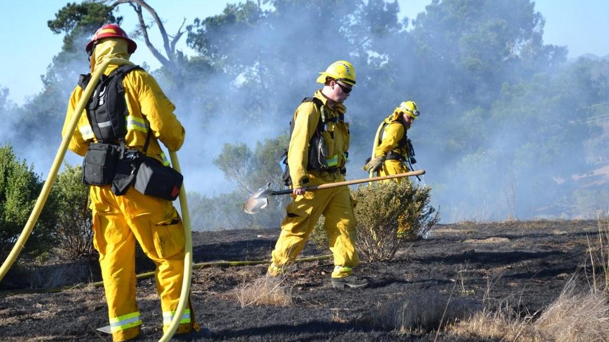 Left to right, Cambria Fire Department’s Capt. Johnathan Gibson, fire engineer Tyson Hamilton and firefighter Tim Grucza fight the fire near Santa Lucia Middle School.