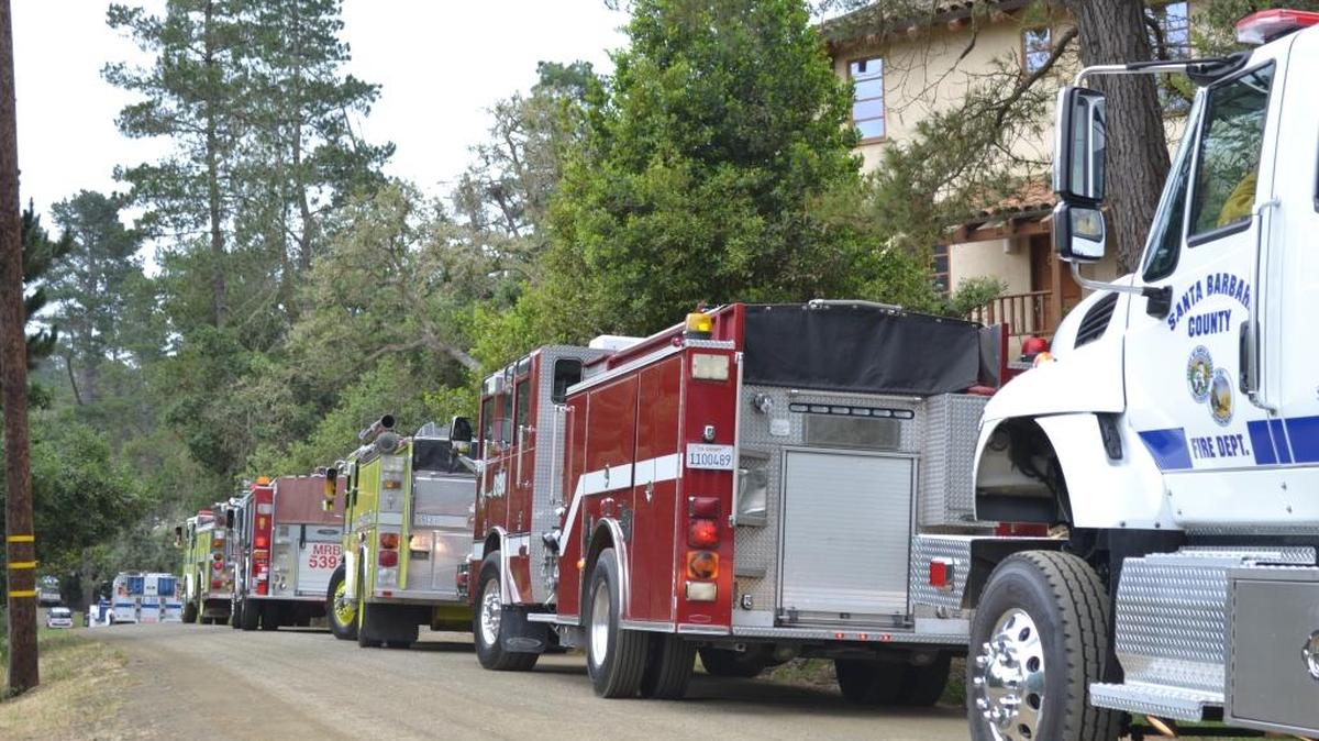 Firefighting vehicles from various agencies parade down Burton Drive near Strawberry Canyon in Cambria on Thursday, May 5.